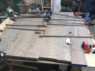 photo of a clamped and glued together table top for a coffee table.