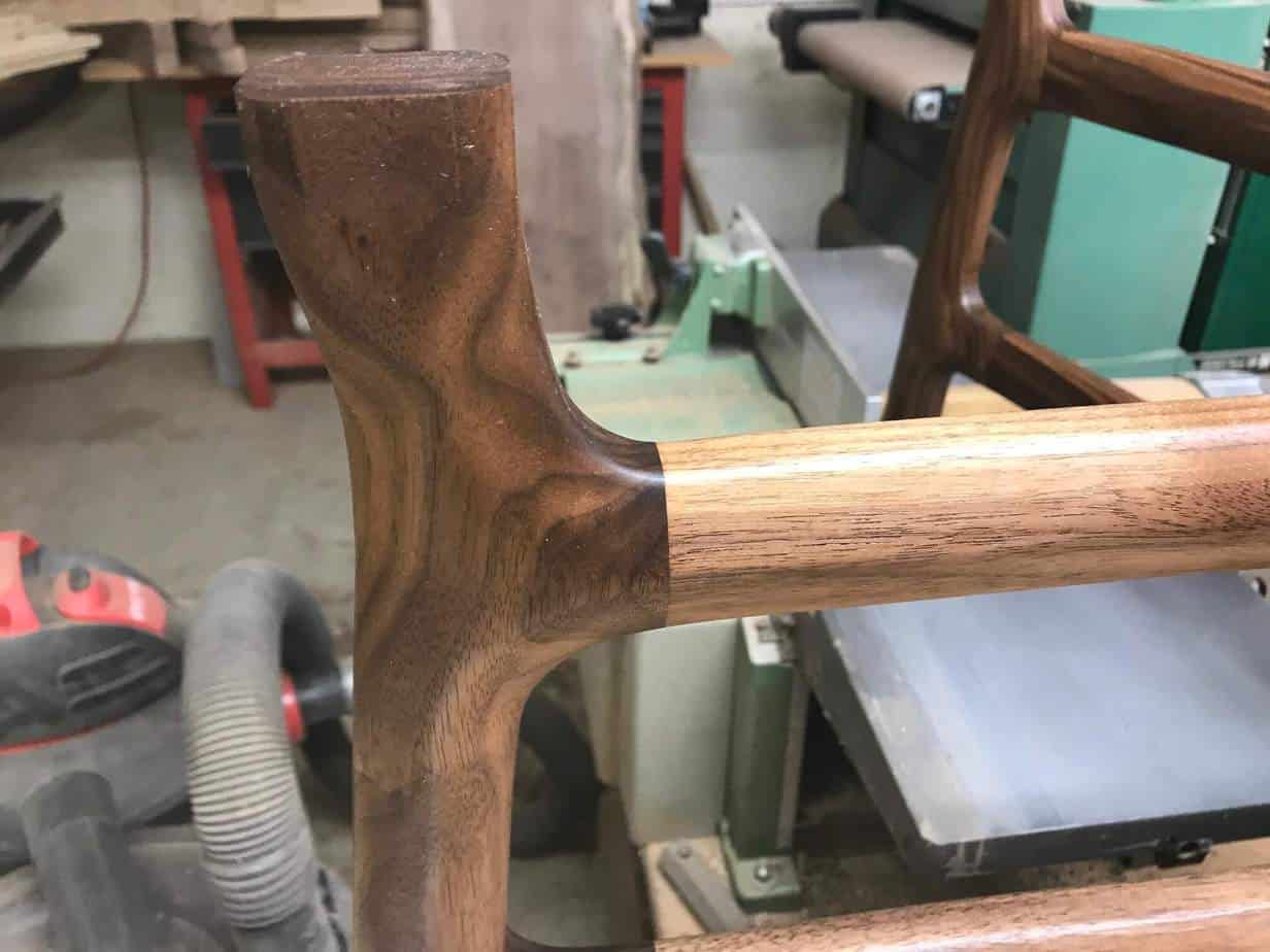 photo of one of the legs of a walnut coffee table in a workshop