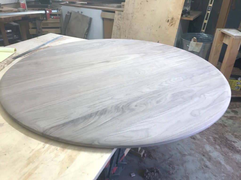 photo of a walnut table top in a workshop