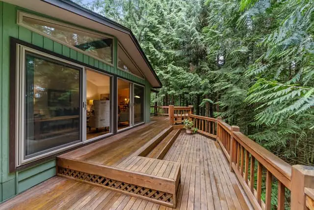 photo of a big teak deck outdoors in a rain forest.