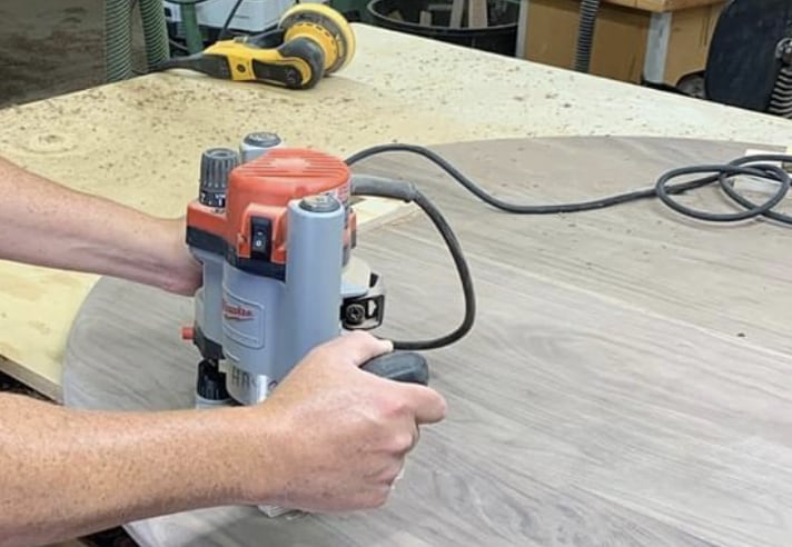 photo of a plunge router being used to make some holes.