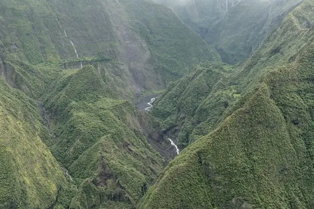 photo of a valley in a rain forest with waterfalls and a river.