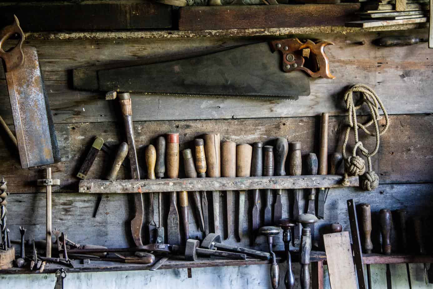 photo of old woodworking tools on a wall.